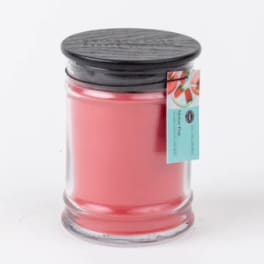 Pink candle in a clear glass jar with a black lid
