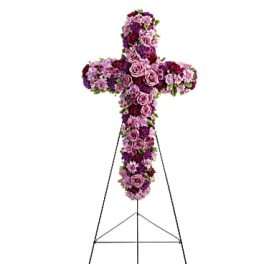 Purple and pink floral cross on a metal stand