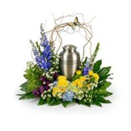 Floral funeral urn arrangement with blue, yellow, and white flowers