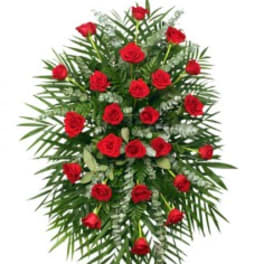 Standing spray of red roses with palm fronds and greenery