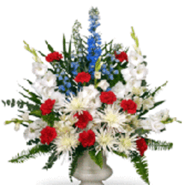Red, white, and blue floral arrangement in a pedestal vase