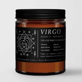 Amber candle in a black-lidded jar with a Virgo label