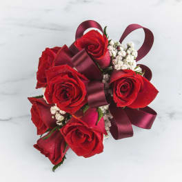 Bouquet of red roses with burgundy ribbon and white filler flowers