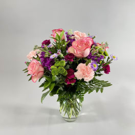 Mixed pink and purple bouquet in a clear glass vase