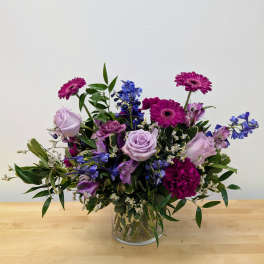 Mixed purple bouquet in a clear glass vase