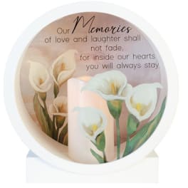 Memorial candle with white calla lilies and a remembrance message