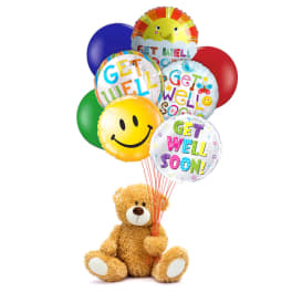 Teddy bear holding a cluster of colorful get-well balloons