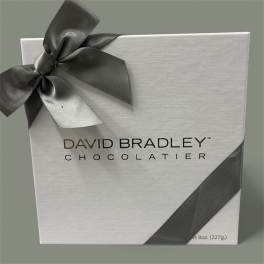 White chocolate gift box with a dark ribbon bow