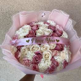 Pink and white rose bouquet with a satin "I love You" ribbon