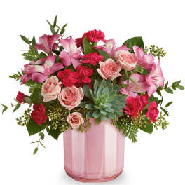 Pink roses and carnations in a pink glass vase