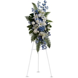 Tall blue and white floral spray on a white easel