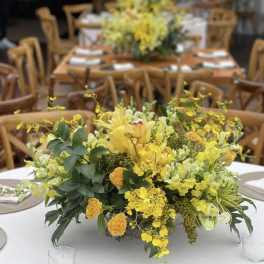 Yellow floral centerpiece on a round table