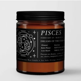 Amber jar candle with a black Pisces label