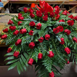 Large arrangement of red roses with fern greenery