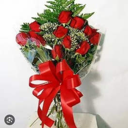 Bouquet of red roses wrapped with a large red ribbon