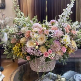 Large pastel flower arrangement in a woven basket