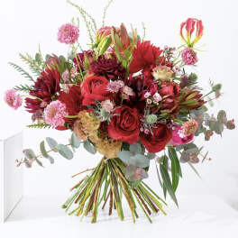 Bouquet of red and pink flowers with eucalyptus