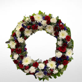 Circular floral wreath with red, white, and blue flowers