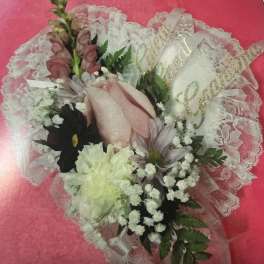 Bouquet of pink and white flowers wrapped in lace paper