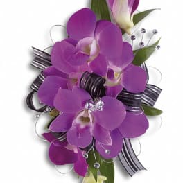 Purple orchid corsage with black ribbon and rhinestone accents