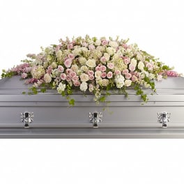 Pastel rose casket spray on a silver casket
