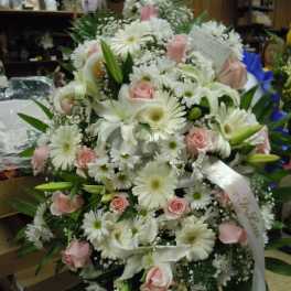 Large white and pink floral spray with lilies, daisies, and roses