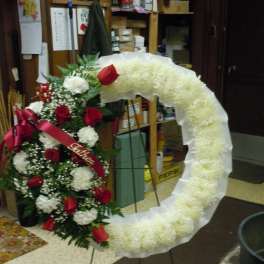 Large funeral wreath with red roses and white flowers