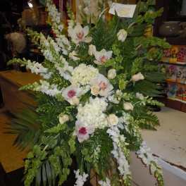 Large white floral spray with orchids, hydrangeas, and trailing blooms