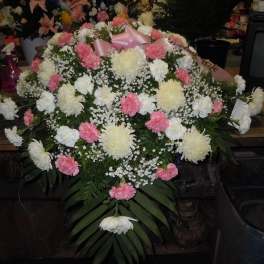 Pink and white carnation arrangement with a pink ribbon