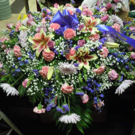 Large mixed floral spray with lilies, roses, and carnations