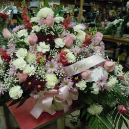 Large mixed bouquet with pink roses, white carnations, and daisies