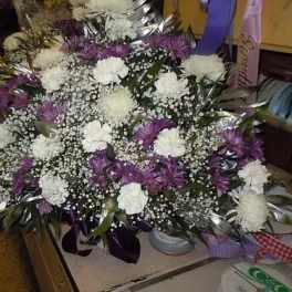 Purple and white floral arrangement with silver leaves