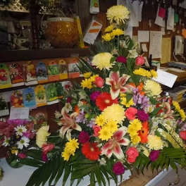 Large mixed flower arrangement with lilies, daisies, and roses