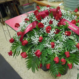 Large red rose arrangement with white baby's breath and ribbon