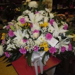 Large white lily and pink carnation arrangement with yellow accents
