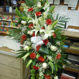 Tall floral spray with white lilies and red carnations