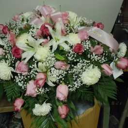 Pink and white floral spray with roses and lilies