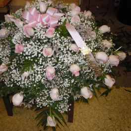Large bouquet of pale pink roses with baby's breath and a pink ribbon