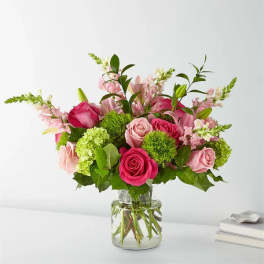 Pink roses and lilies in a clear glass vase