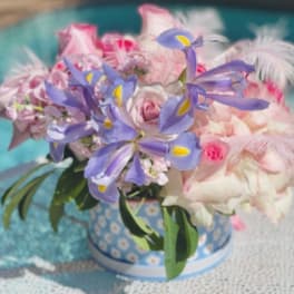 Bouquet of pink and lavender flowers in a patterned blue vase