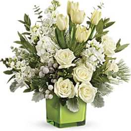 White roses and tulips in a green glass vase