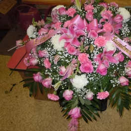 Large pink floral spray with lilies, roses, and carnations