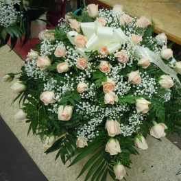 Heart-shaped rose arrangement with white baby's breath and a ribbon