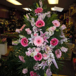 Tall pink and white funeral spray with lilies and gerbera daisies