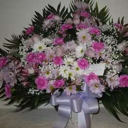 Large pink and white floral spray with a lavender ribbon bow