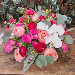 Mixed bouquet of pink and red roses with white orchids