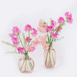 Two small pink glass vases filled with pink and peach sweet pea flowers