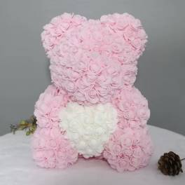 Pink and white rose teddy bear on a table