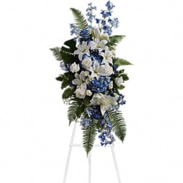 White and blue floral standing spray on an easel