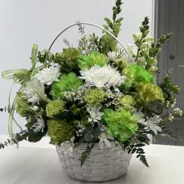 Green and white flower basket with a handle